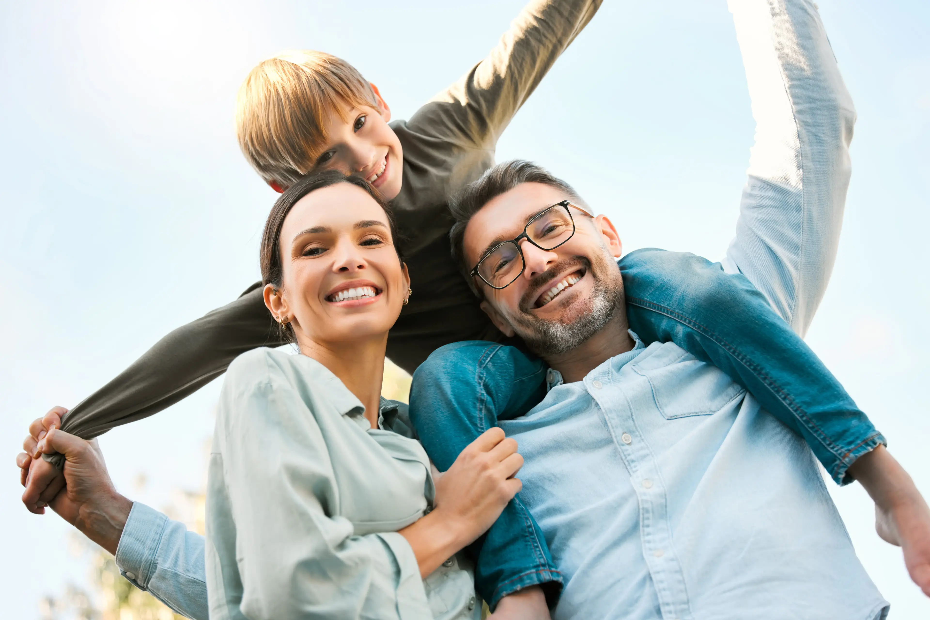 Happy family outdoors, patients of Dr. Maged Youssef